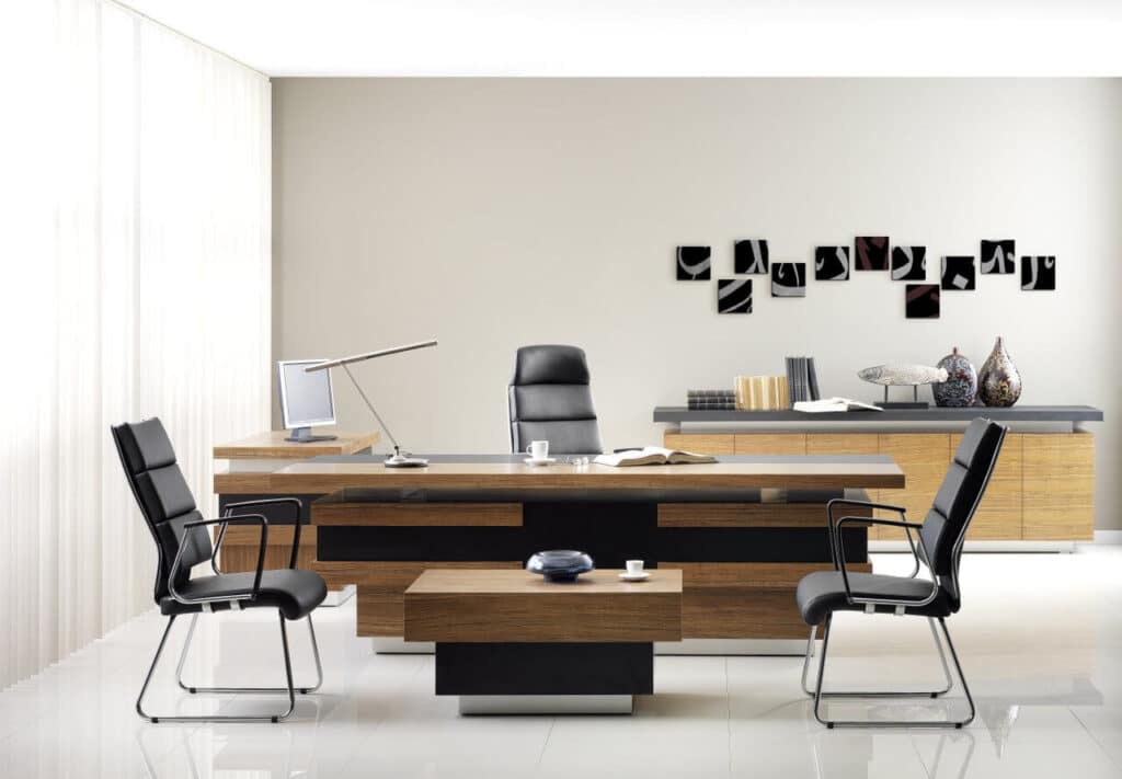 Modern office with a sleek desk, two chairs, and artistic wall decor.