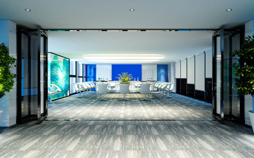 Modern conference room with a long table, chairs, plants, and large colorful artwork on the walls.