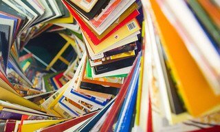 A swirling spiral of colorful magazines and books viewed from above.